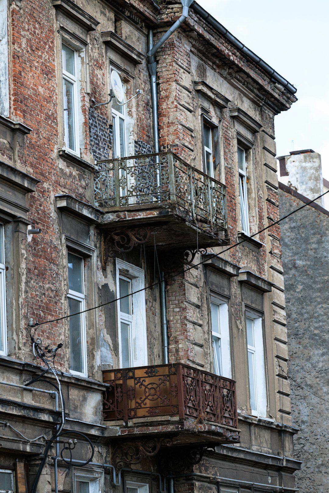 Close up of a weathered apartment building facade with balconies